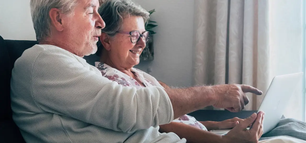 A senior couple looking at a laptop together