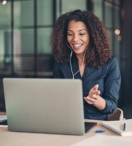 Woman communicating over virtual meeting with her laptop