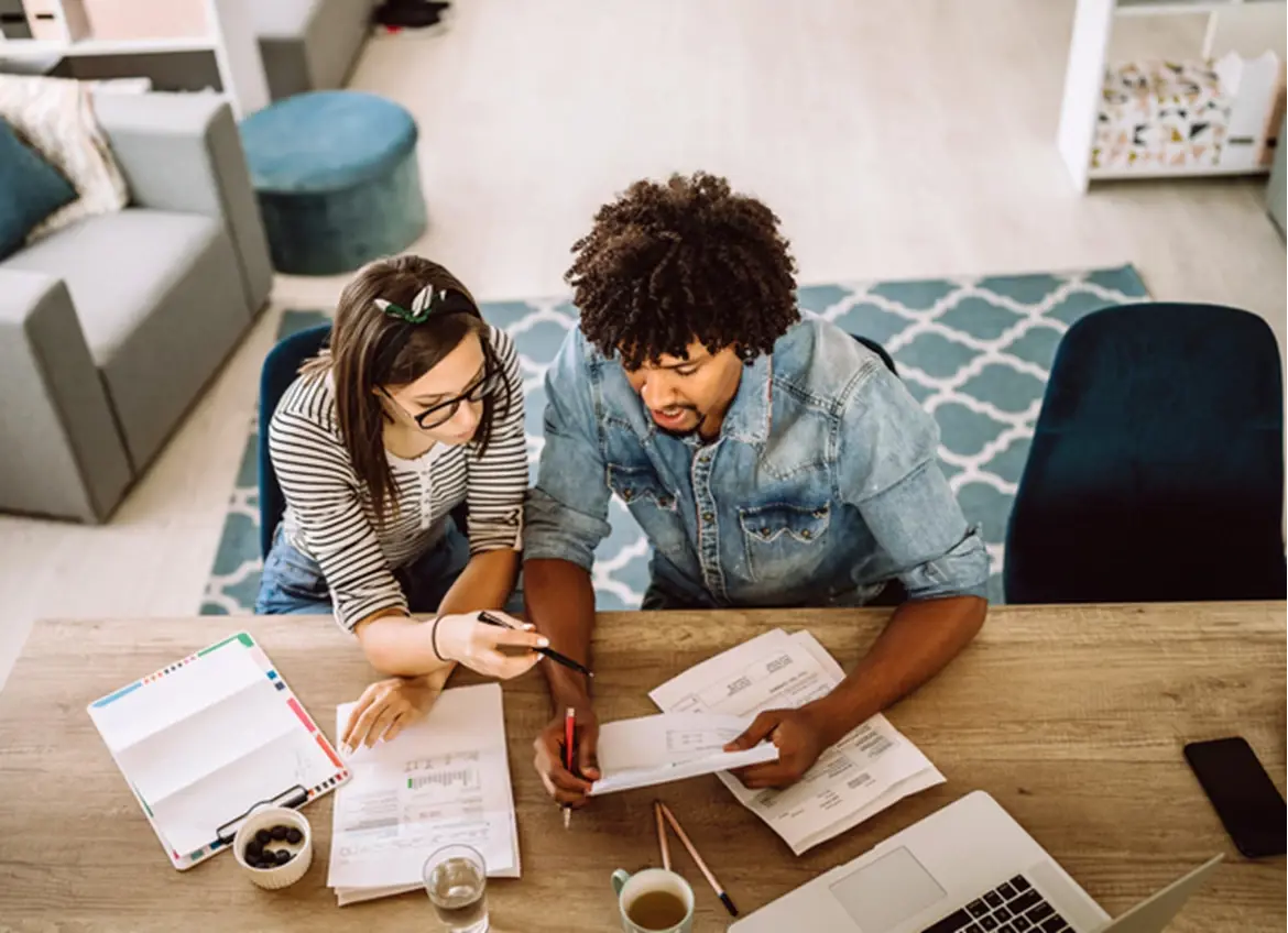 A couple carefully reviewing bills together