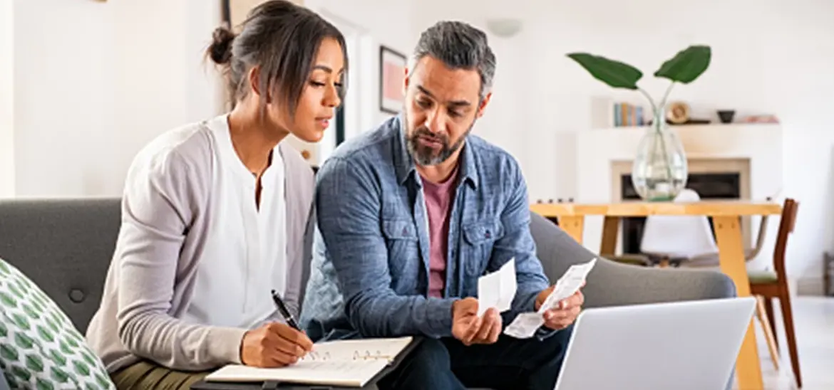 Couple reviewing receipts and making notes