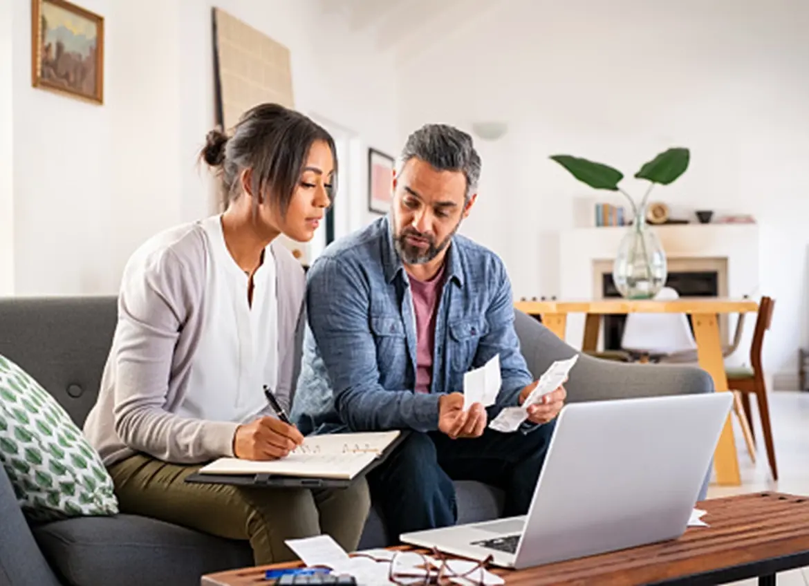 Couple reviewing receipts and making notes