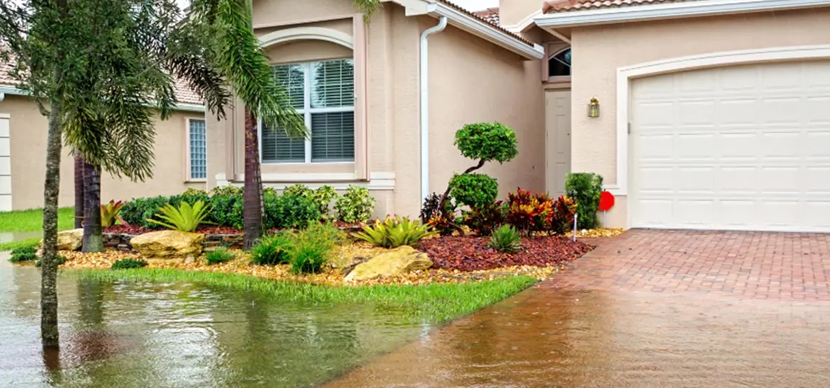 A single home with flooded front yard and driveway