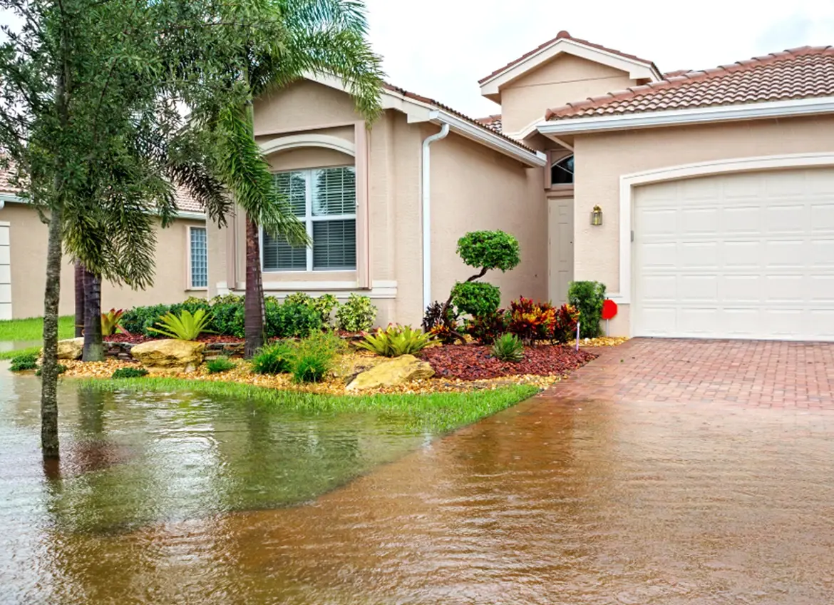 A single home with flooded front yard and driveway