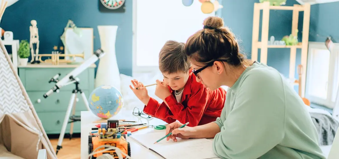 Mom helping her son with school work in his room