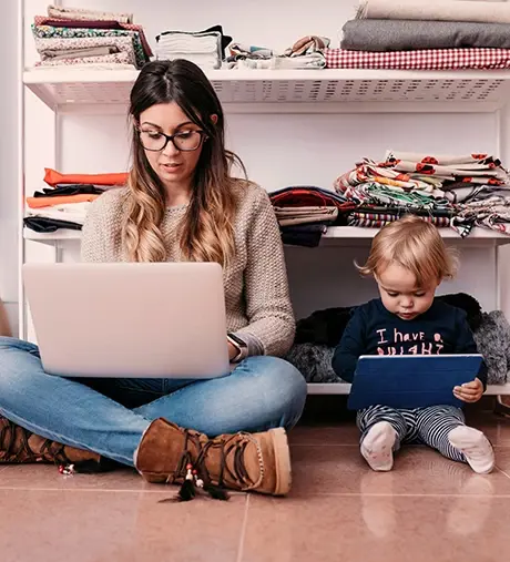 Mom and baby sitting on floor and looking at their own digital screen