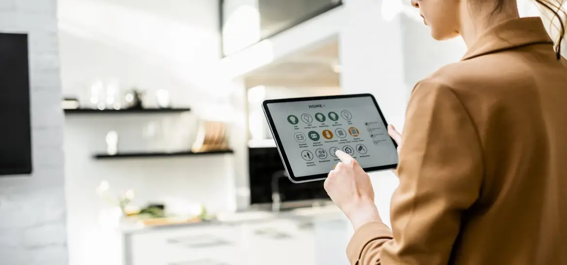 A woman looking at a tablet with the Home remote control app