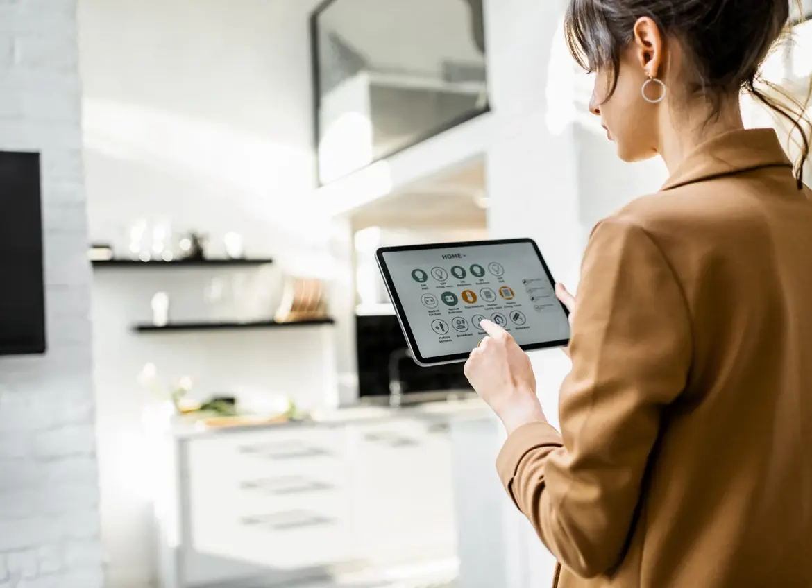 A woman looking at a tablet with the Home remote control app