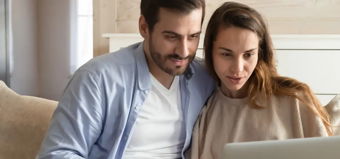 A couple looking at a laptop screen together