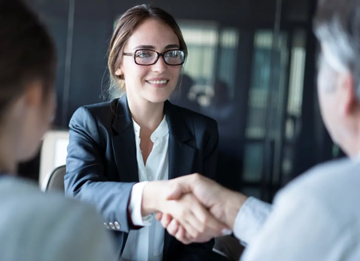 A sales agent shaking hands with a customer